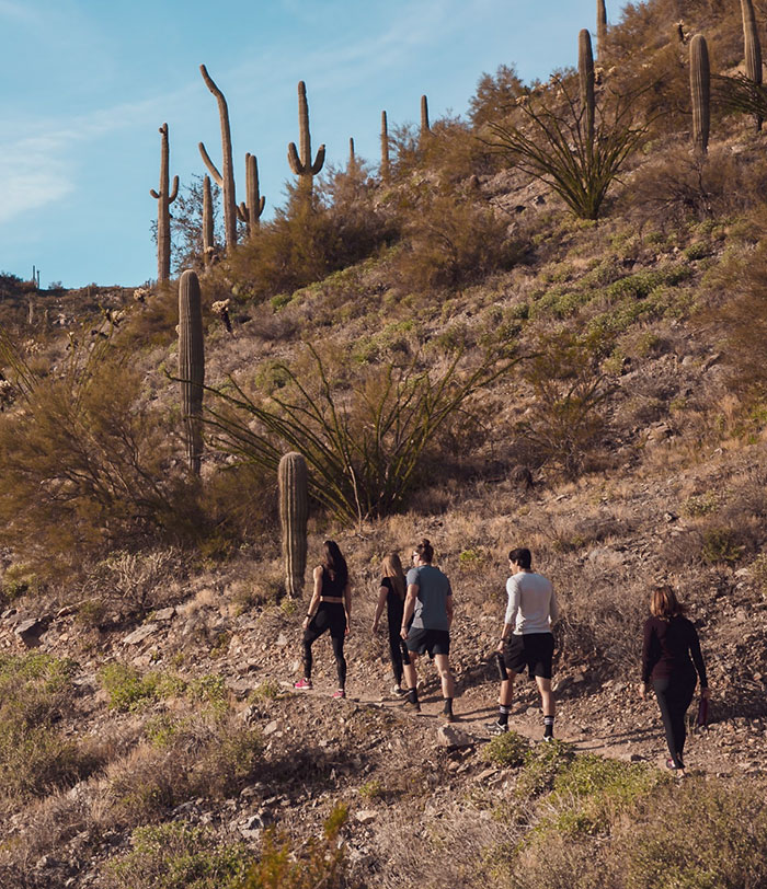 Group hiking a desert trail at CIVANA